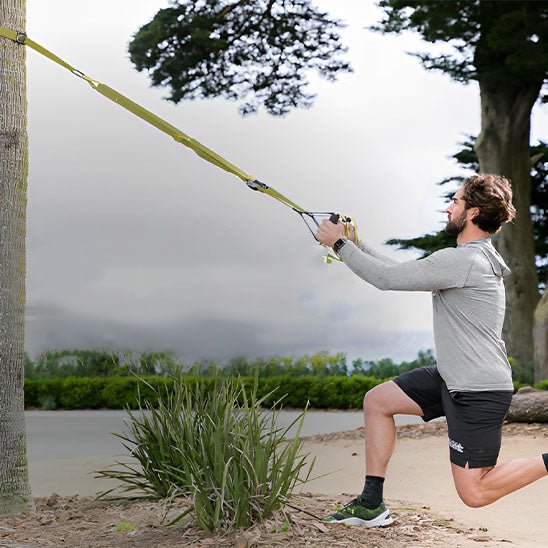 homme en exterieur en tirant bras avec elastique sport